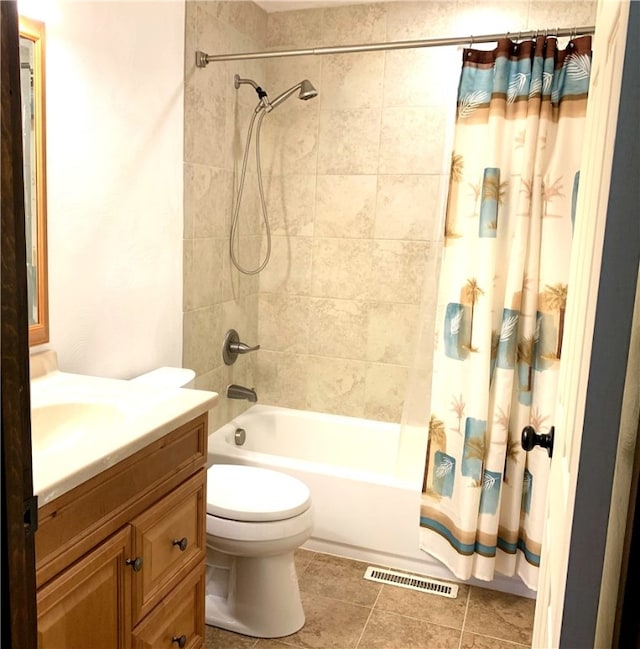 bathroom featuring shower / tub combo with curtain, visible vents, toilet, vanity, and tile patterned flooring