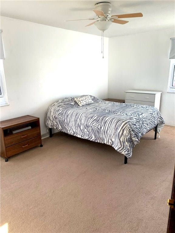 bedroom featuring ceiling fan and light colored carpet