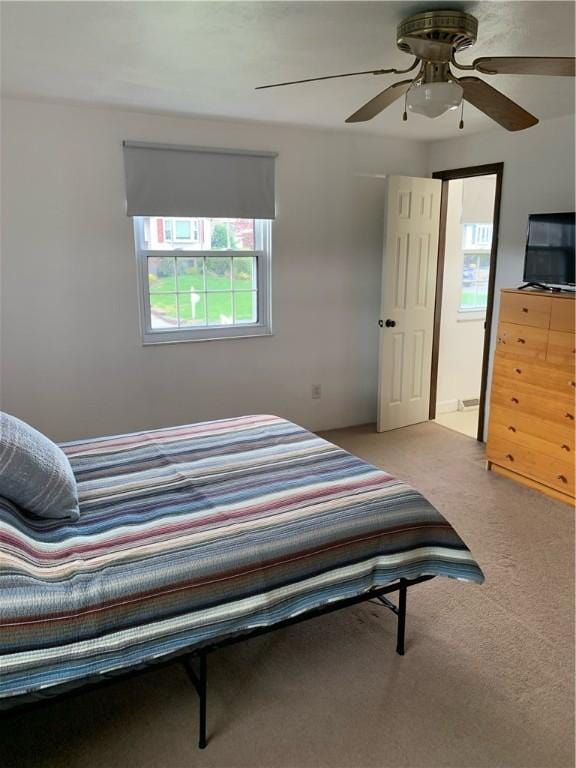 carpeted bedroom with ceiling fan