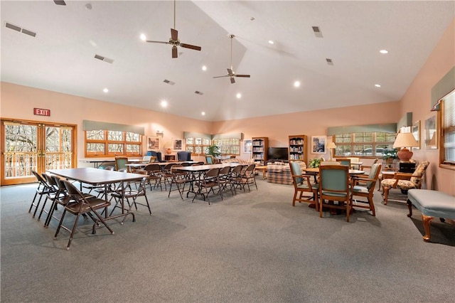 dining space with high vaulted ceiling, carpet flooring, and visible vents