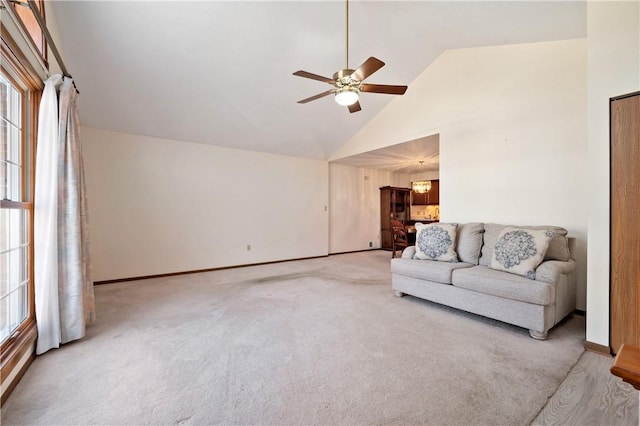 carpeted living room featuring baseboards, high vaulted ceiling, and a ceiling fan