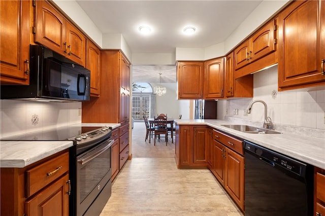 kitchen with black appliances, a sink, light countertops, and brown cabinets