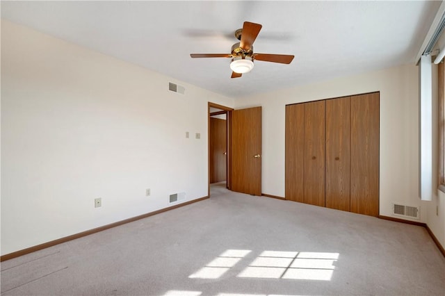 unfurnished bedroom with a closet, carpet flooring, and visible vents