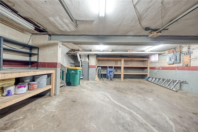 interior space featuring concrete block wall and electric panel