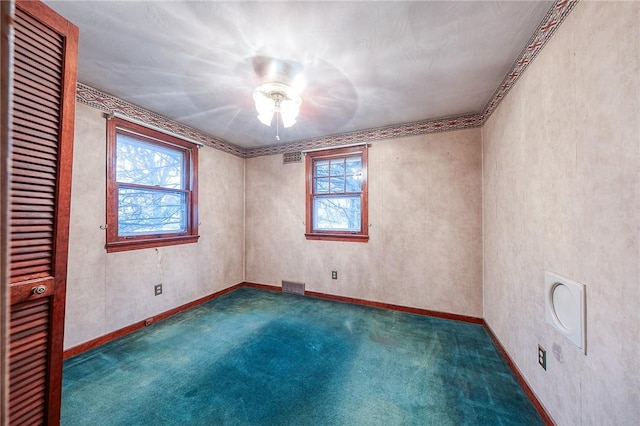 carpeted spare room with visible vents and baseboards