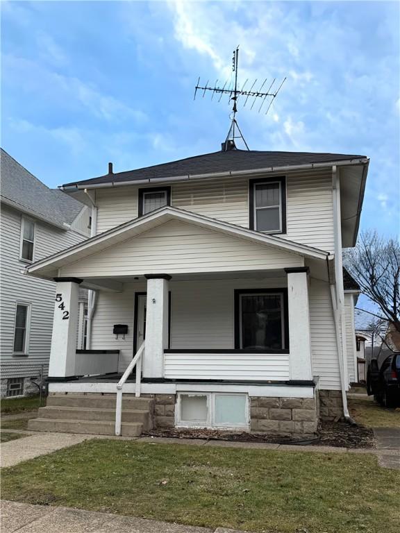 view of front of house with a porch and a front lawn