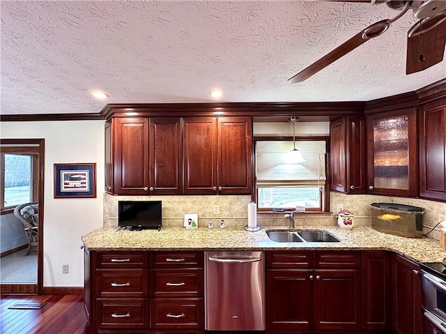 kitchen featuring reddish brown cabinets, appliances with stainless steel finishes, a sink, and tasteful backsplash