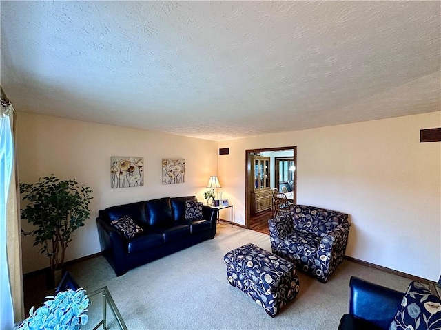 carpeted living room featuring visible vents, a textured ceiling, and baseboards