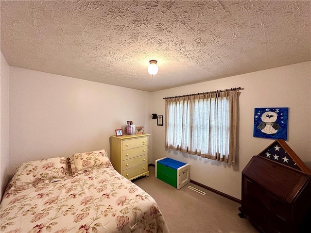 carpeted bedroom with a textured ceiling and baseboards