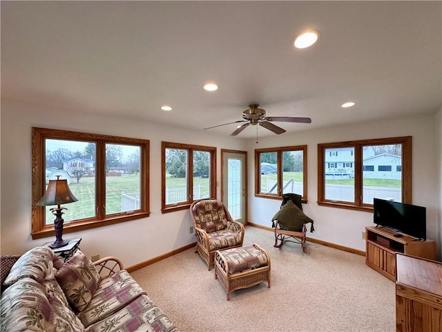 living room with a ceiling fan, recessed lighting, light colored carpet, and baseboards