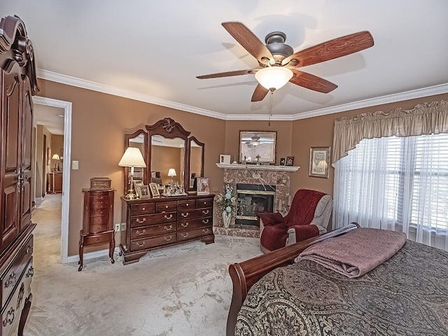 carpeted bedroom featuring a ceiling fan, a glass covered fireplace, crown molding, and baseboards