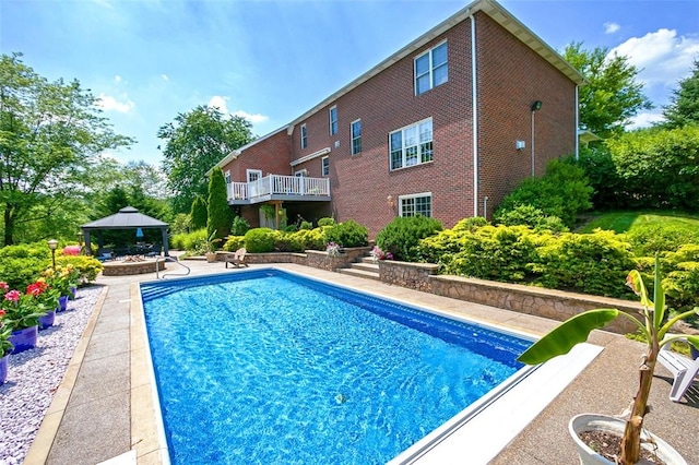 outdoor pool with a patio and a gazebo