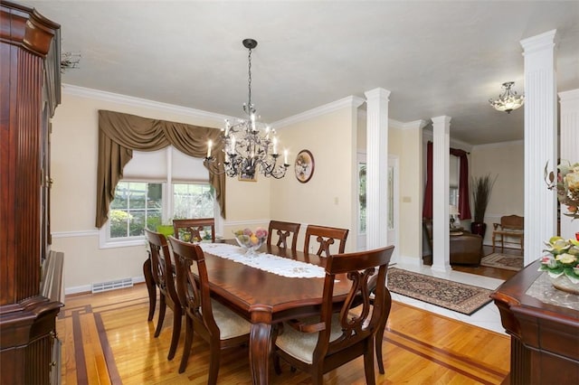 dining area featuring visible vents, light wood-style flooring, and ornate columns