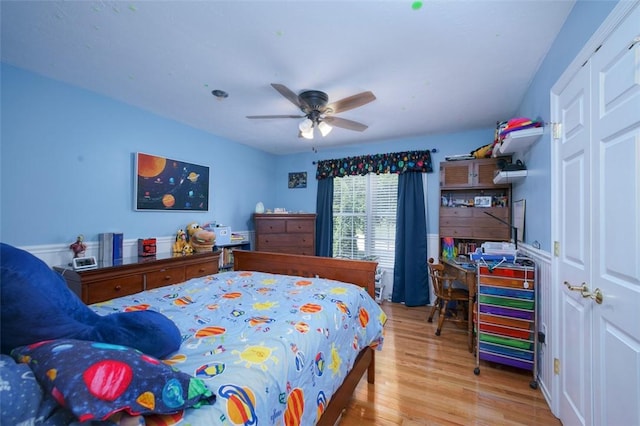 bedroom with light wood-style flooring and a ceiling fan