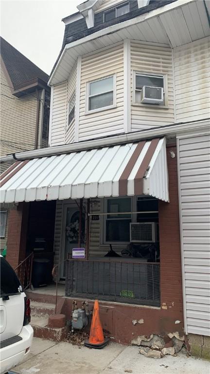 view of front of home featuring a porch and cooling unit