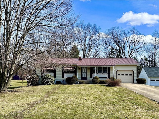 ranch-style home with driveway, a garage, metal roof, covered porch, and a front yard