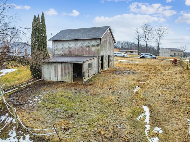 view of side of property featuring an outbuilding