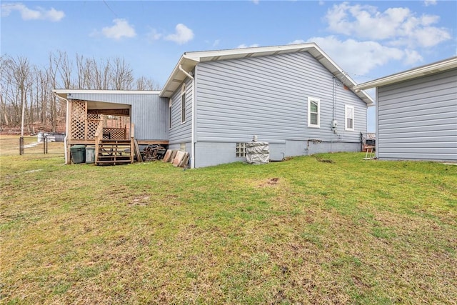 view of side of property featuring fence and a yard