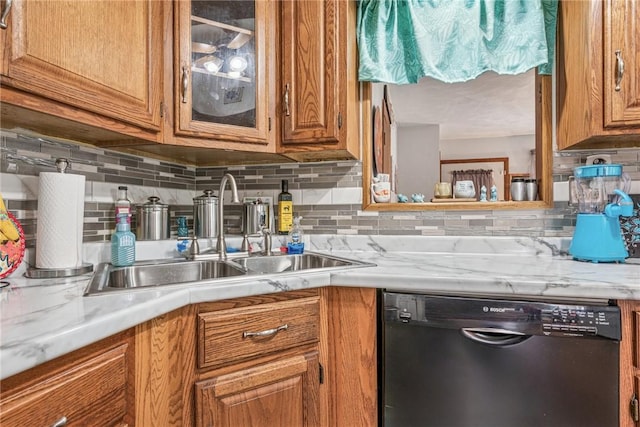 kitchen with a sink, brown cabinets, dishwasher, and light countertops