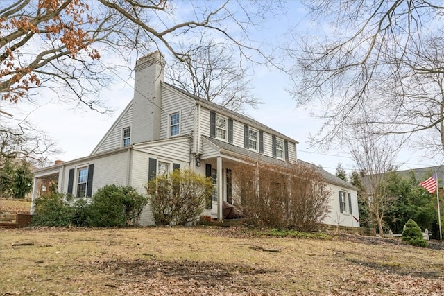 view of side of home featuring a chimney