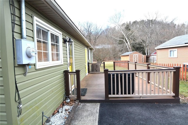 exterior space featuring an outbuilding, a shed, and a wooden deck