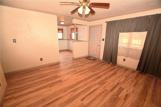 empty room with light wood-style floors, baseboards, ornamental molding, and a ceiling fan