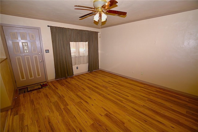 unfurnished room with a ceiling fan, baseboards, ornamental molding, and wood finished floors