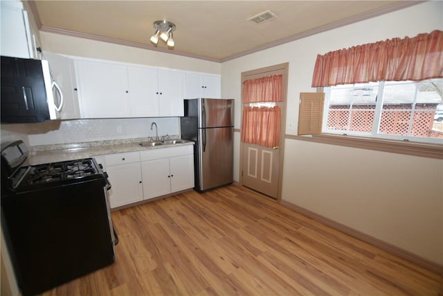 kitchen featuring a sink, visible vents, white cabinets, light countertops, and appliances with stainless steel finishes