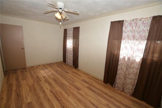 unfurnished bedroom featuring ceiling fan, crown molding, and wood finished floors