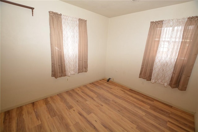 unfurnished room featuring wood finished floors