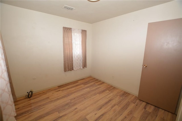 unfurnished room featuring visible vents and light wood-style floors