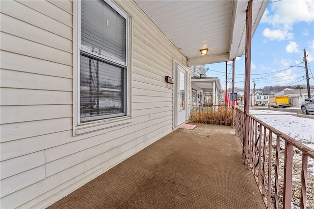 view of side of property featuring covered porch