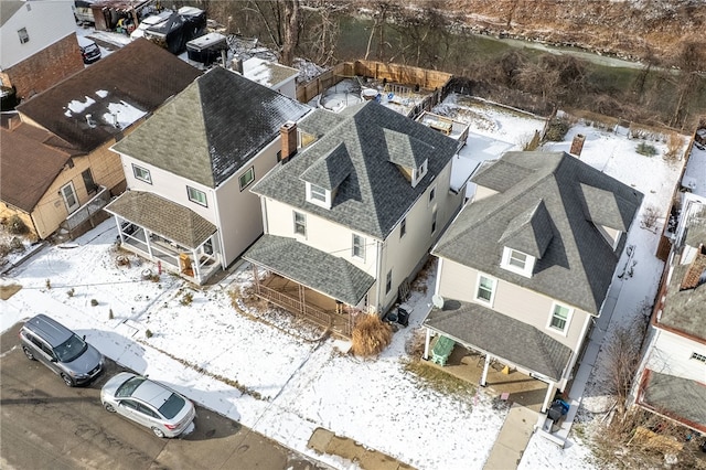 snowy aerial view with a residential view