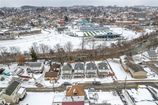 snowy aerial view featuring a residential view