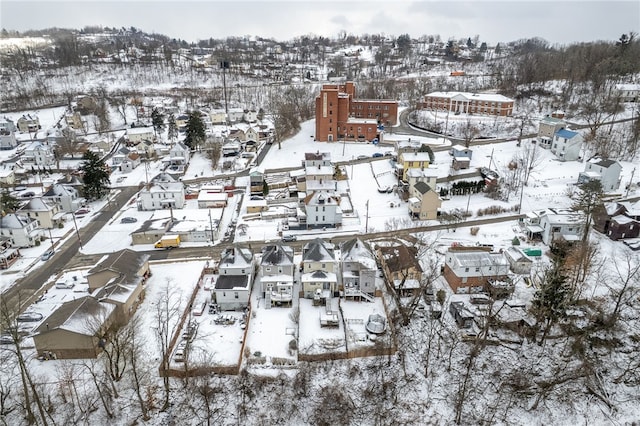 snowy aerial view with a residential view