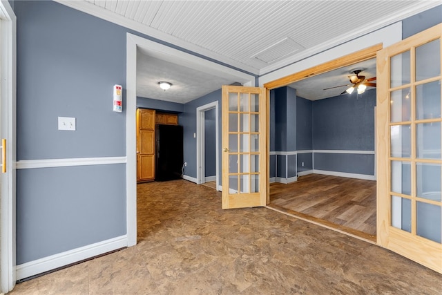 unfurnished room with ceiling fan, french doors, and baseboards