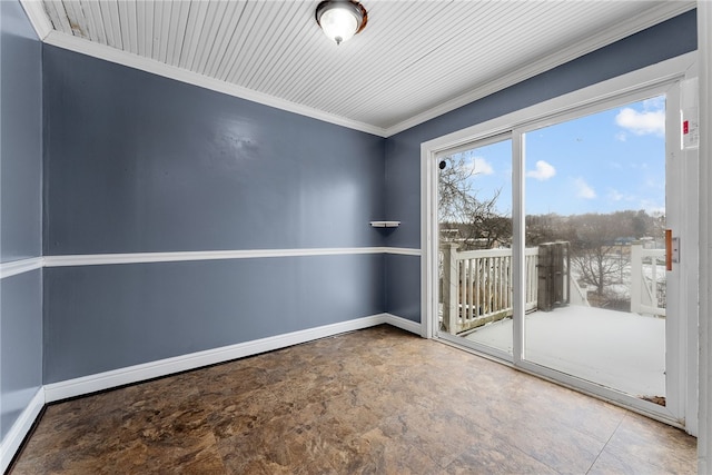 empty room featuring crown molding and baseboards