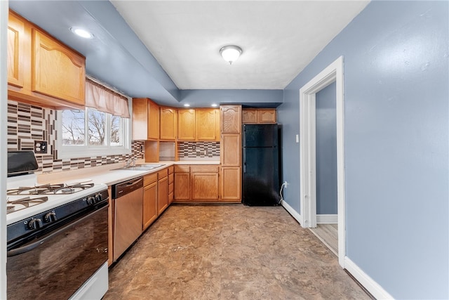 kitchen featuring range with gas stovetop, tasteful backsplash, freestanding refrigerator, dishwasher, and baseboards