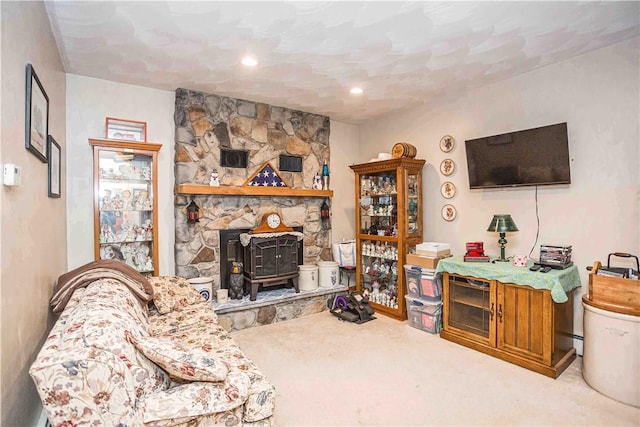 carpeted living room with a wood stove and recessed lighting