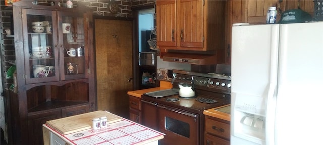 kitchen with white refrigerator with ice dispenser, brown cabinets, light countertops, and range with electric stovetop