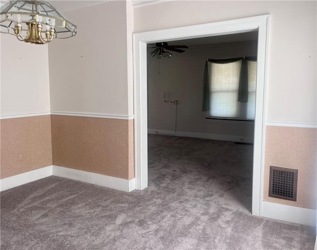 interior space featuring an inviting chandelier, carpet floors, baseboards, and visible vents