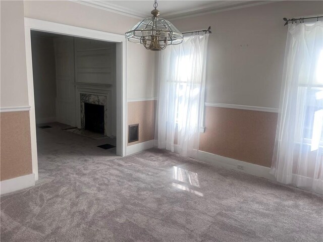 unfurnished living room with carpet flooring, a chandelier, visible vents, and plenty of natural light