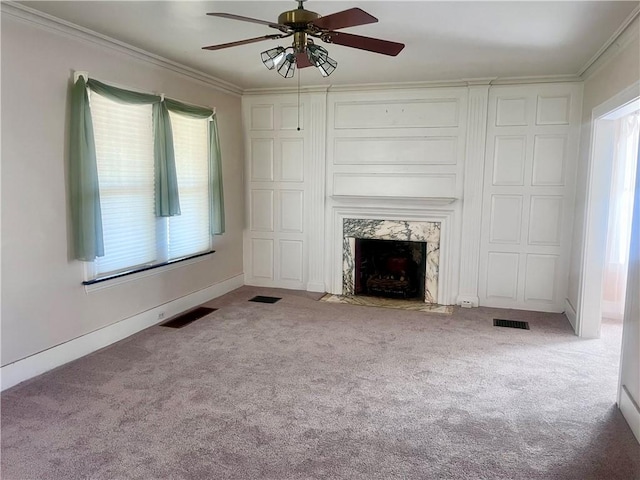 unfurnished living room with a wealth of natural light, ornamental molding, a ceiling fan, and visible vents