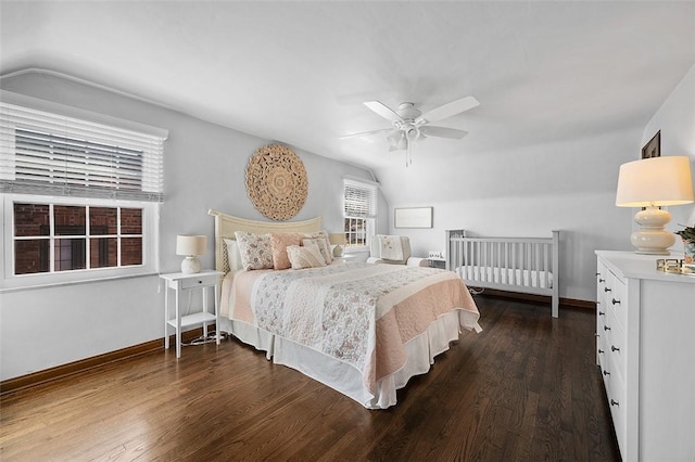 bedroom featuring lofted ceiling, baseboards, and dark wood-style flooring