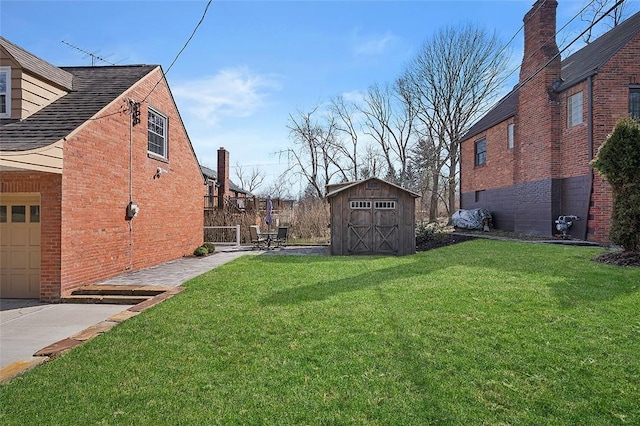 view of yard with a garage, an outdoor structure, and a storage shed