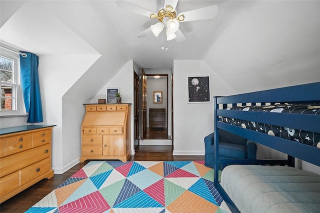 bedroom featuring a ceiling fan, lofted ceiling, dark wood finished floors, and baseboards