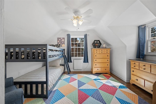 bedroom with lofted ceiling, ceiling fan, wood finished floors, and baseboards