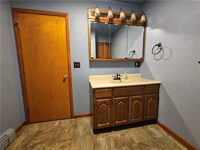 bathroom featuring baseboard heating, vanity, and baseboards