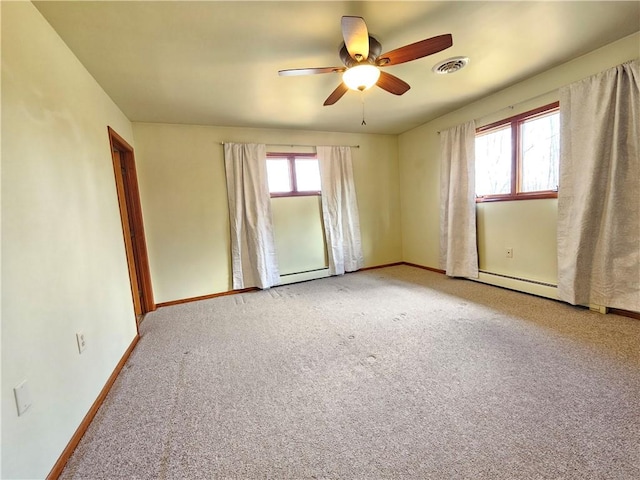 empty room featuring visible vents, a baseboard heating unit, carpet, baseboards, and ceiling fan