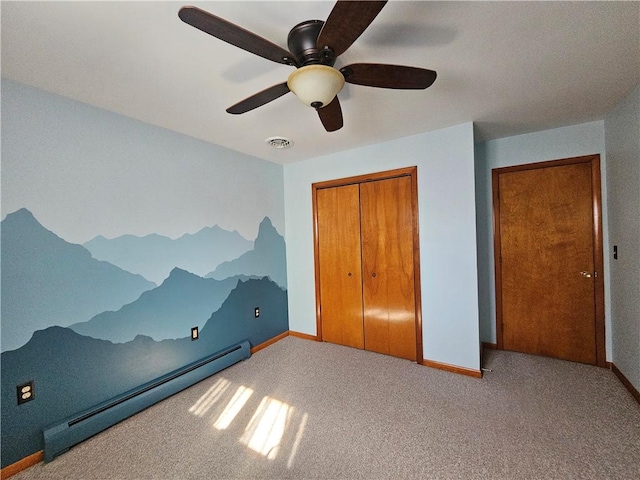 unfurnished bedroom with visible vents, baseboards, carpet floors, baseboard heating, and a closet